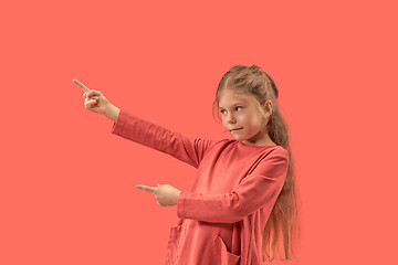 Image showing Cute little surprised girl in coral dress with long hair smiling to camera