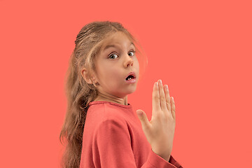 Image showing Cute little surprised girl in coral dress with long hair smiling to camera