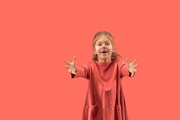 Image showing Cute little girl in coral dress with long hair smiling to camera