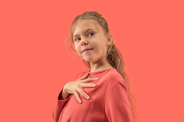 Image showing Cute little girl in coral dress with long hair smiling to camera