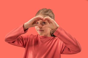 Image showing young girl forming a heart with her fingers