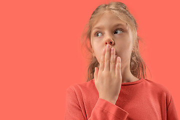 Image showing Cute little surprised girl in coral dress with long hair smiling to camera