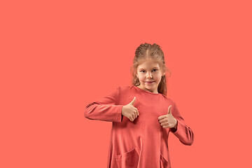 Image showing Cute little girl in coral dress with long hair smiling to camera