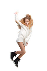 Image showing Cute little girl jump. Studio shot. White background
