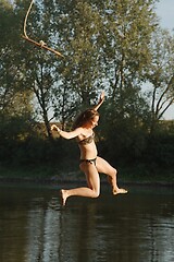 Image showing Rope swing river jump