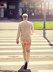 Image showing senior man walking along city crosswalk