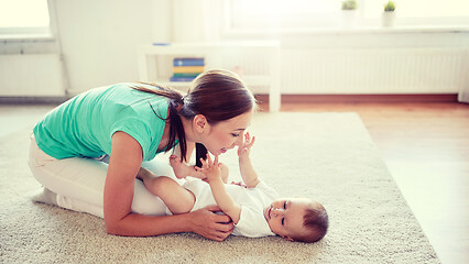 Image showing happy mother playing with baby at home