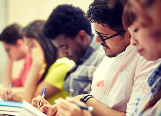 Image showing group of international students writing at lecture