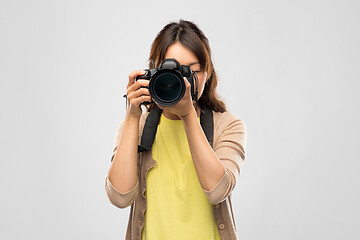 Image showing female photographer with digital camera