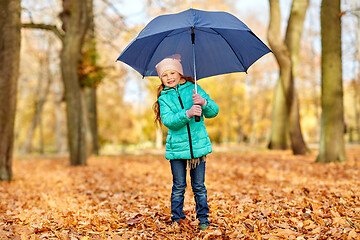 Image showing happy little girl with umbrella at autumn park