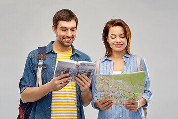 Image showing happy couple of tourists with city guide and map