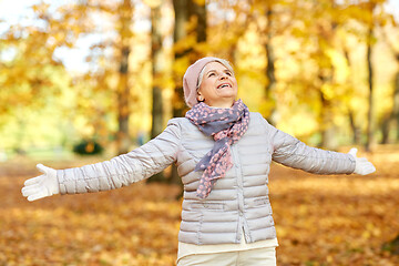 Image showing happy senior woman enjoying beautiful autumn