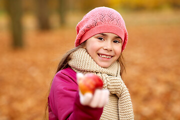 Image showing happy girl with apple at autumn park