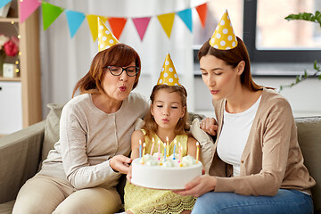 Image showing mother, daughter, grandmother with birthday cake