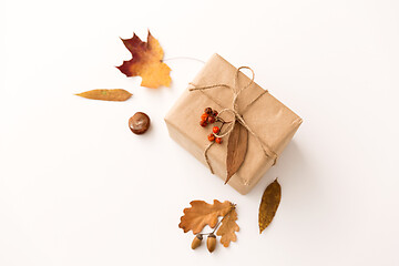 Image showing gift box, autumn leaves, acorns and rowanberry