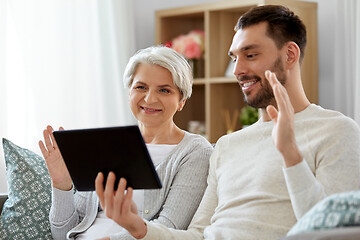 Image showing old mother and adult son with tablet pc at home