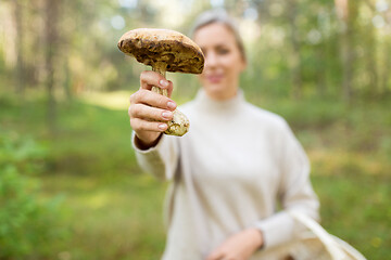 Image showing young woman with mushroom in autumn forest