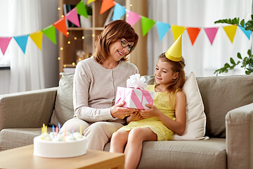 Image showing grandmother giving granddaughter birthday gift