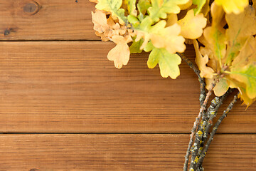 Image showing oak leaves in autumn colors on wooden table