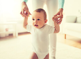 Image showing happy baby learning to walk with mother help