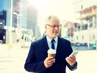 Image showing businessman with smartphone and coffee in city