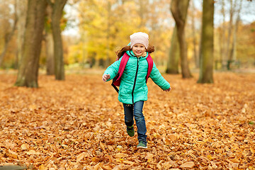 Image showing happy student girl with schoolbag at autumn park