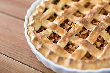 Image showing close up of apple pie in mold on wooden table