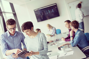 Image showing Two Business People Working With Tablet in office