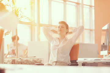 Image showing young business woman relaxing at workplace