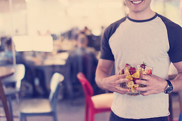 Image showing software developer eating a fruit salad