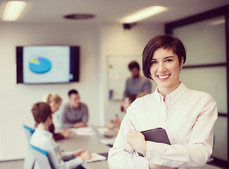 Image showing hispanic businesswoman with tablet at meeting room