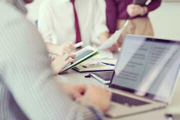 Image showing close up of  businessman hands  using tablet on meeting