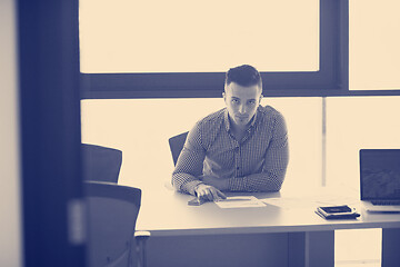 Image showing young businessman at his desk in office