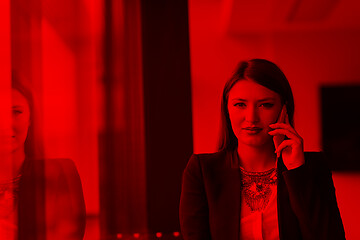 Image showing Business Girl Standing In A Modern Building Near The Window With