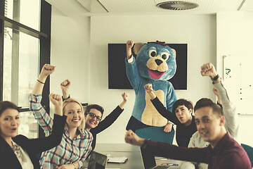 Image showing boss dresed as bear having fun with business people in trendy of