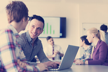 Image showing young business couple working on laptop, businesspeople group on