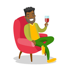 Image showing African-american man drinking wine in the chair.