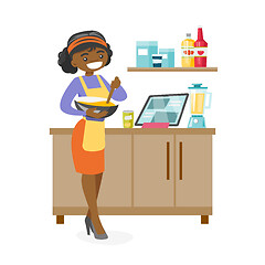 Image showing Young african-american woman whisking dough.