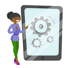 Image showing African-american woman pointing at big tablet.