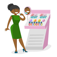 Image showing Young african-american woman buying lipstick.