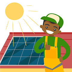 Image showing Young african constructor installing solar panel