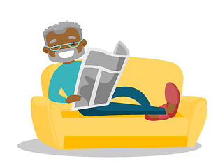 Image showing Man laying on the couch and reading a newspaper.