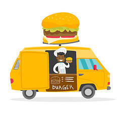 Image showing African-american street seller selling burgers.