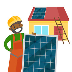 Image showing Young african constructor installing solar panel.