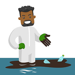 Image showing Man standing in water with oil spill and bottles.