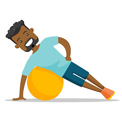 Image showing Young african-american man exercising with fitball