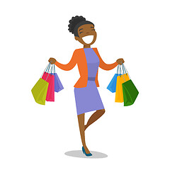 Image showing Young african-american woman holding shopping bags