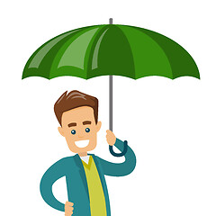 Image showing Caucasian insurance agent standing under umbrella.