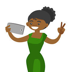 Image showing Young african woman making selfie with a cellphone