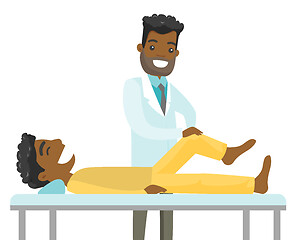 Image showing African physio checking the leg of a patient.